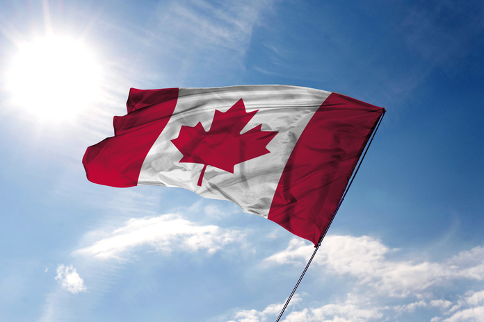 canadian-flag-with-sky-clouds.webp
